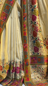 Elegant Cream Banarasi Silk Saree with Multicolor Floral Jaal Weaving, Rich Contrasting Zari Border, Traditional Pallu Design, and Intricate Meenakari Detailing Perfect for Festivals, Weddings, and Cultural Celebrations
